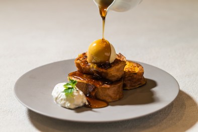 Photo: Soft French toast topped with soft serve ice cream, served with whipped cream and drizzled with maple syrup