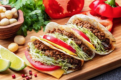 Photo: Tacos stuffed with ingredients such as guacamole, tomato, cheese, and salsa sauce